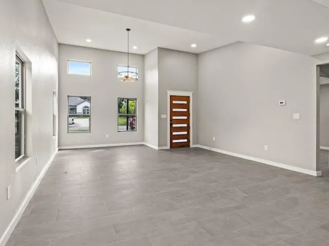 an empty room with windows and closet