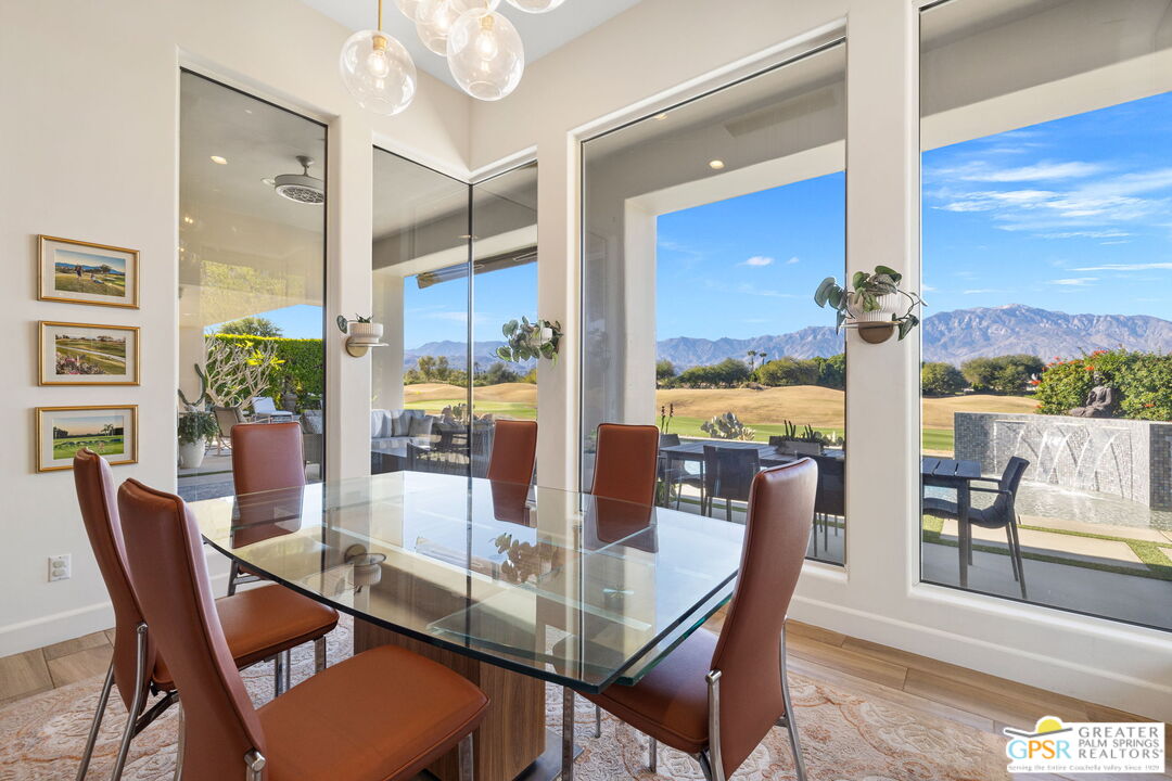 182 Loch Lomond Road Rancho Mirage, CA 92270 - Photo 18 of 48 a dining room with furniture a chandelier and large windows