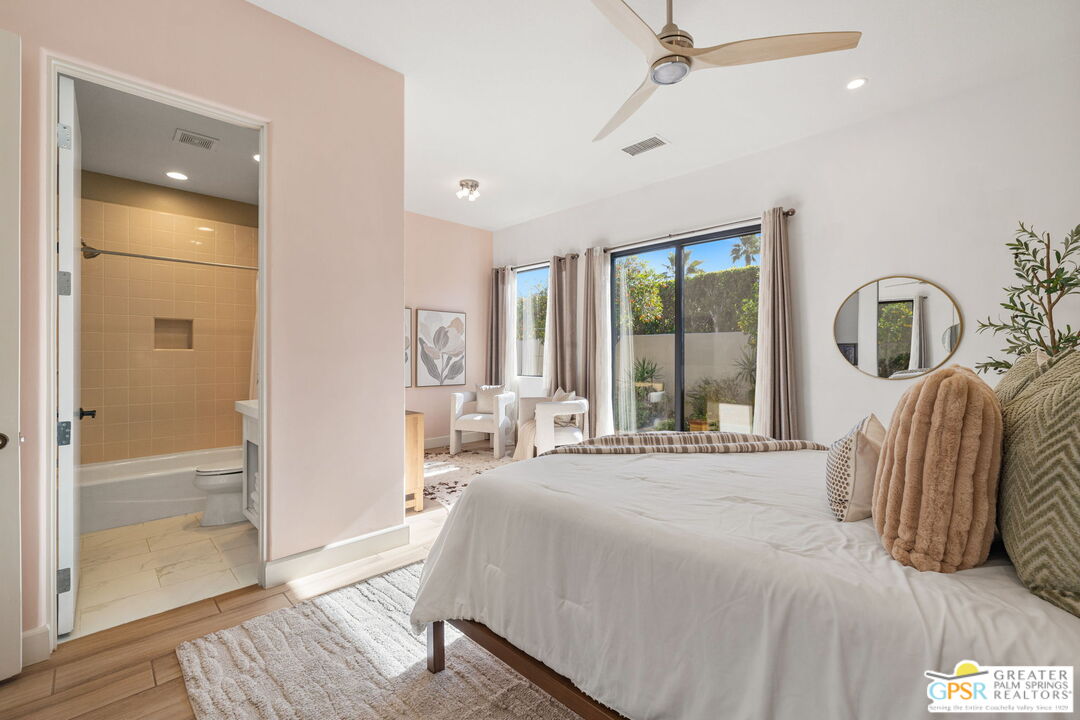 182 Loch Lomond Road Rancho Mirage, CA 92270 - Photo 30 of 48 a bedroom with a bed and large window with wooden floor