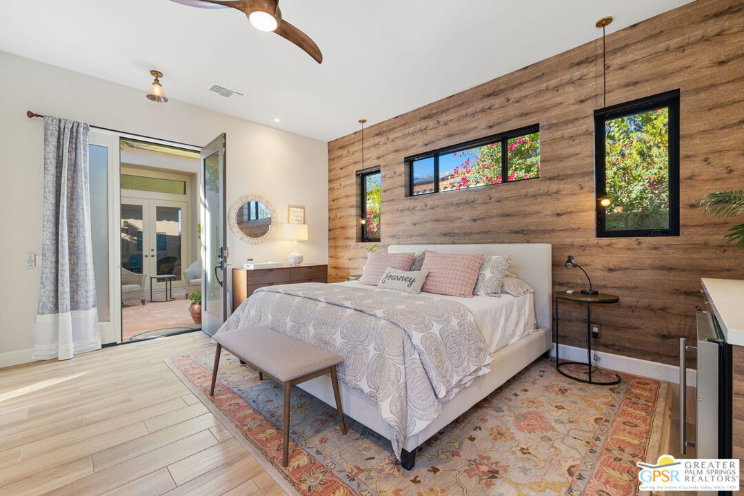 182 Loch Lomond Road Rancho Mirage, CA 92270 - Photo 38 of 48 a spacious bedroom with a bed a dresser and large window