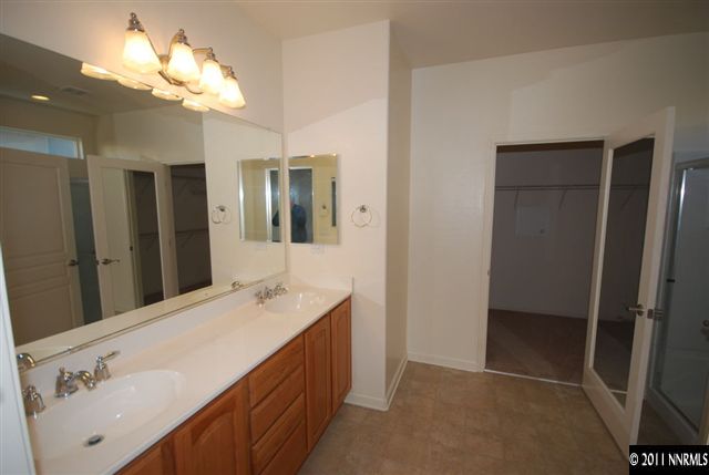 1930 Evergreen Ridge Way Reno, NV 89523 - Photo 7 of 13 a bathroom with a double vanity sink and a mirror
