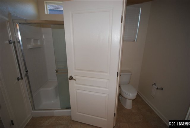 1930 Evergreen Ridge Way Reno, NV 89523 - Photo 8 of 13 a bathroom with a granite countertop toilet and a sink