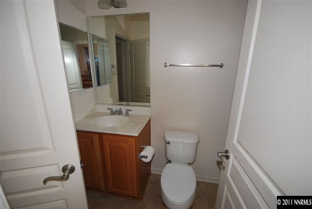 1930 Evergreen Ridge Way Reno, NV 89523 - Photo 9 of 13 a bathroom with a toilet a sink and mirror