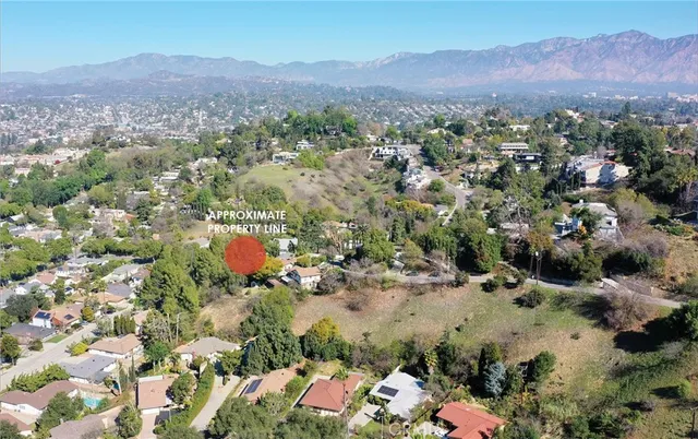 an aerial view of a house with a yard