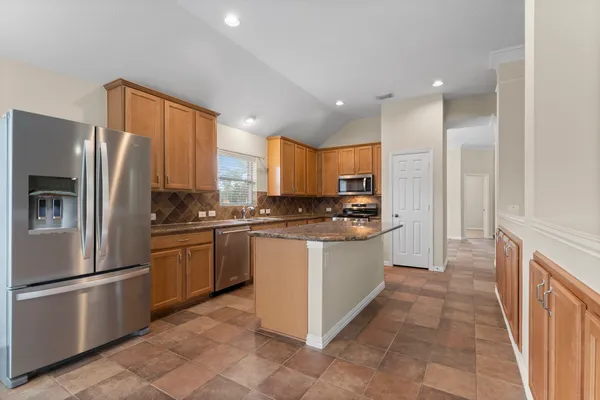 a bathroom with a tub a toilet and a shower