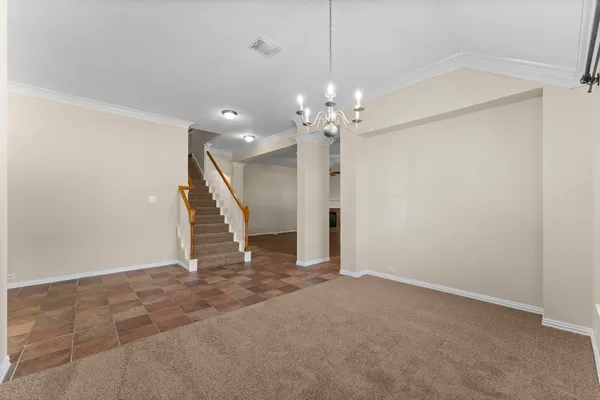 an empty room with wooden floor fireplace and windows