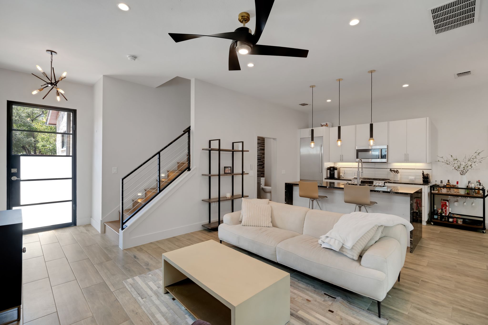 809 Bouldin Avenue Austin, TX 78704 - Photo 30 of 39 Living room featuring light wood-style floors, suspended lighting, and a ceiling fan
