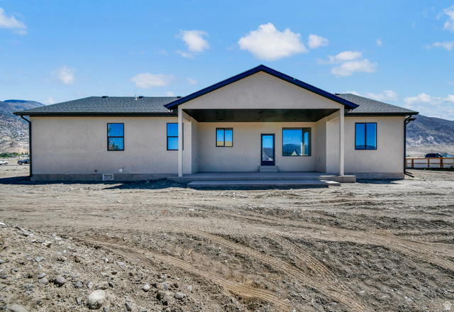 840 South Jones Road Monroe, UT 84754 - Photo 34 of 52 Stucco exterior with a dark shingle roof, featuring a covered concrete patio