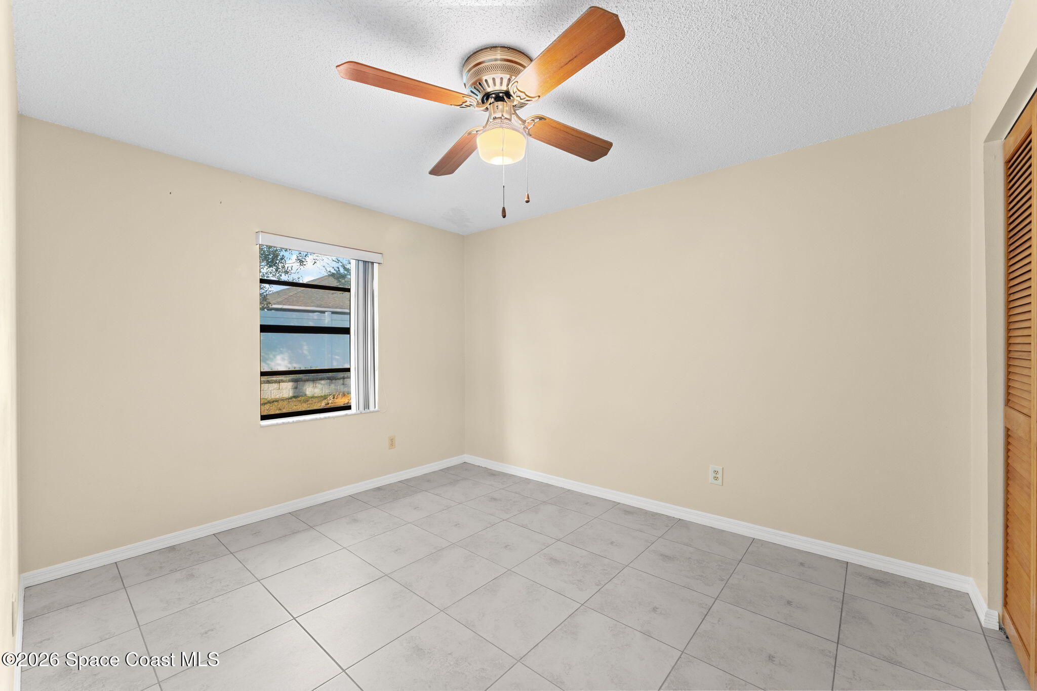 960 Pineland Drive Rockledge, FL 32955 - Photo 18 of 32 an empty room with windows and ceiling fan