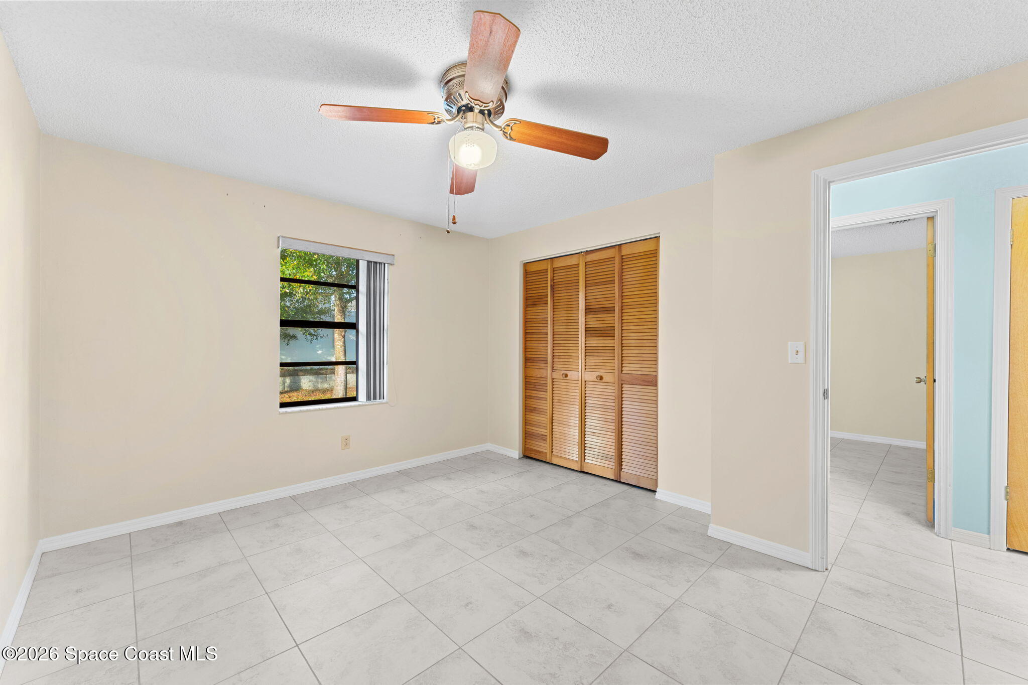 960 Pineland Drive Rockledge, FL 32955 - Photo 19 of 32 an empty room with windows and fan