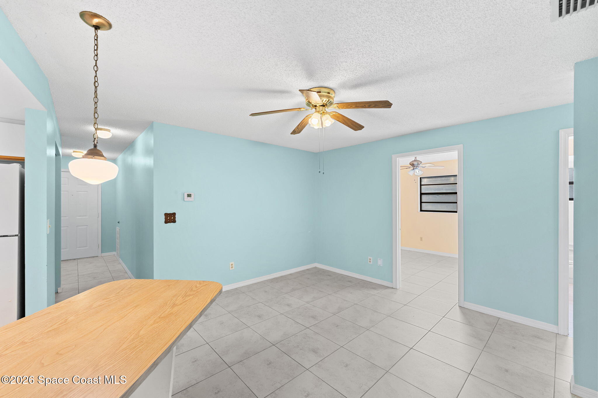 960 Pineland Drive Rockledge, FL 32955 - Photo 8 of 32 a bedroom with a bed and a chandelier