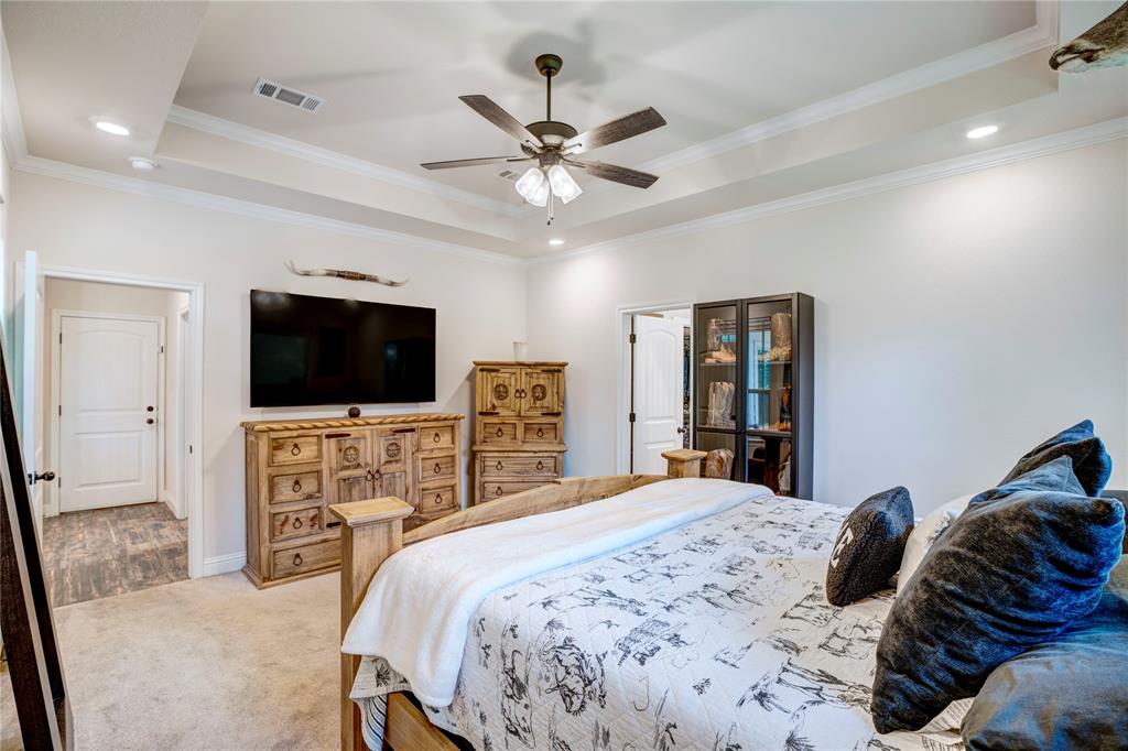 1355 Jay Bird Road Springtown, TX 76082 - Photo 25 of 40 a bedroom with a bed and a flat screen tv