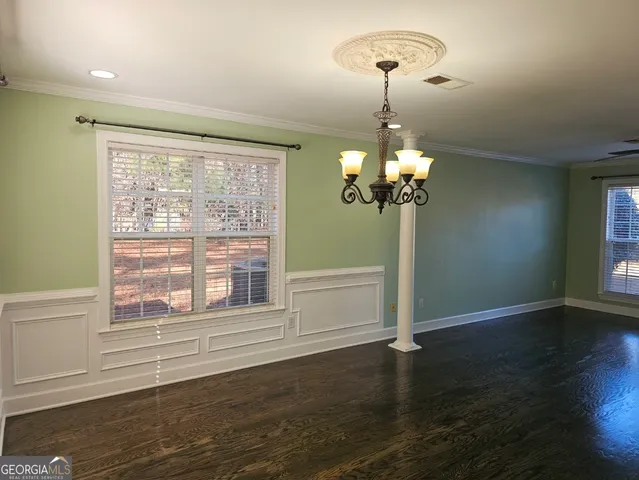 a view of staircase with railing and a chandelier