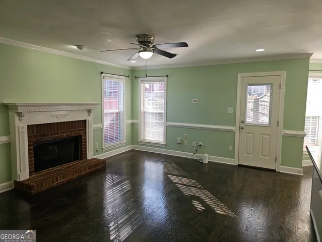 a view of an empty room with a chandelier fan