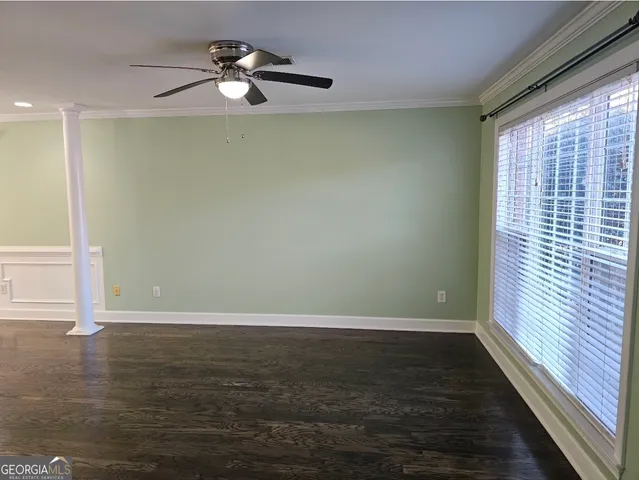 a living room with a fireplace and wooden floor