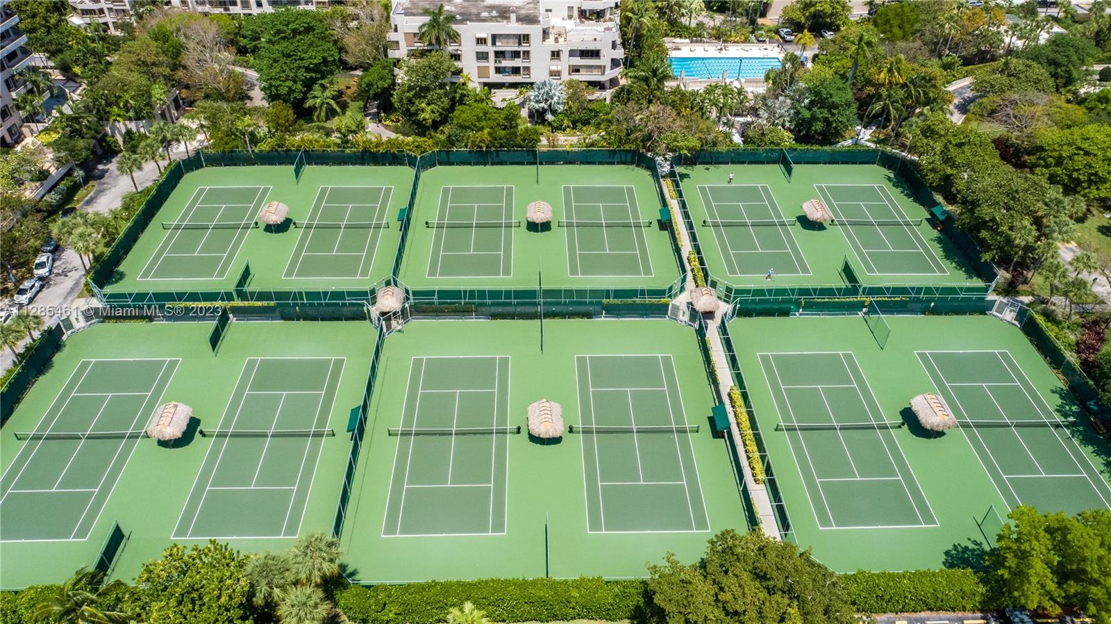 151 Crandon Boulevard, Unit 1023 Key Biscayne, FL 33149 - Photo 17 of 55 an aerial view of a tennis ground and a large ground