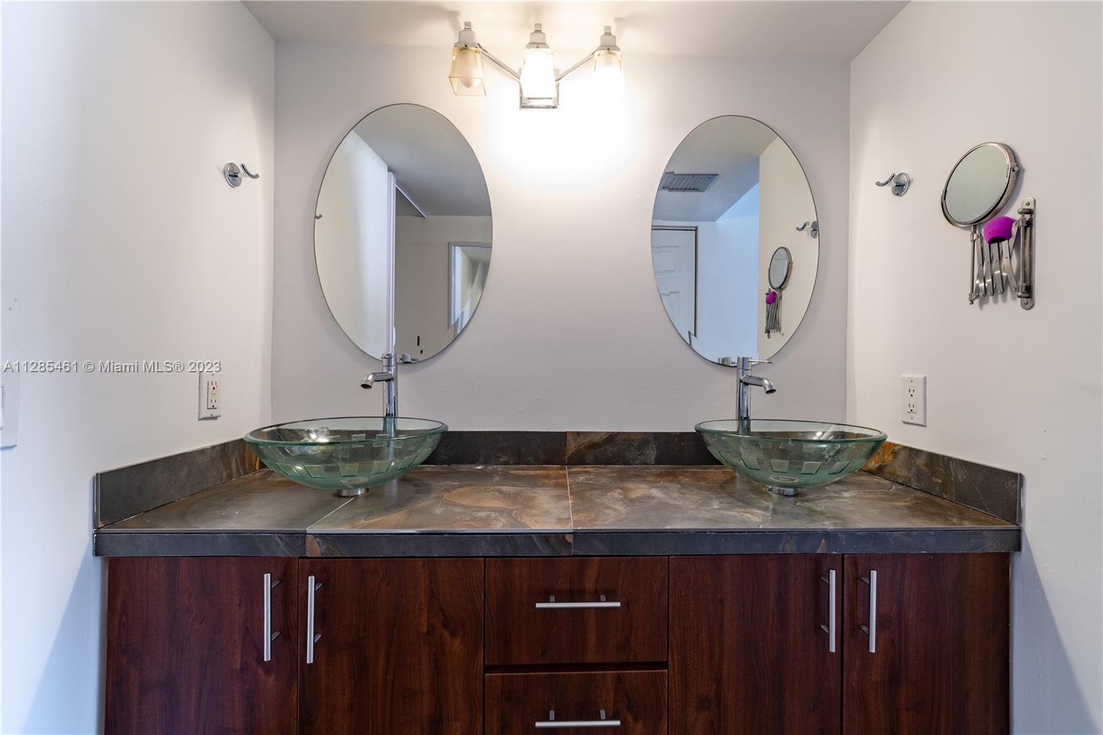 151 Crandon Boulevard, Unit 1023 Key Biscayne, FL 33149 - Photo 34 of 55 a bathroom with a granite countertop sink and a mirror