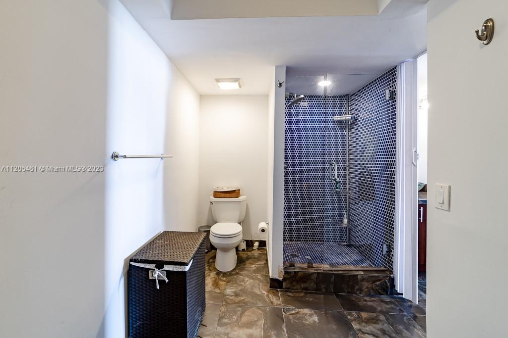 151 Crandon Boulevard, Unit 1023 Key Biscayne, FL 33149 - Photo 38 of 55 a bathroom with a toilet a sink and shower