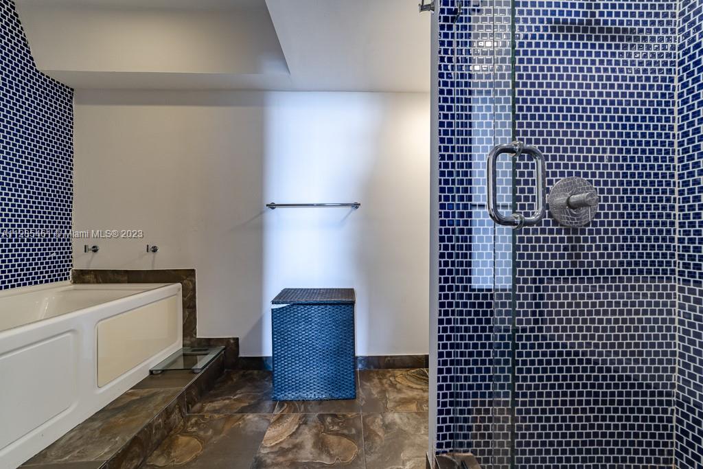 151 Crandon Boulevard, Unit 1023 Key Biscayne, FL 33149 - Photo 39 of 55 a bathroom with a bathtub and shower