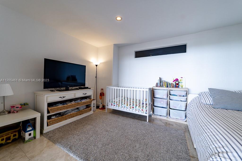 151 Crandon Boulevard, Unit 1023 Key Biscayne, FL 33149 - Photo 44 of 55 a living room with furniture and a flat screen tv
