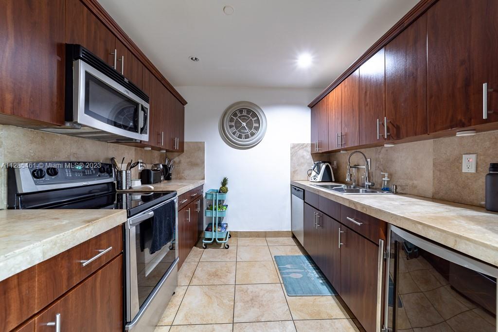 151 Crandon Boulevard, Unit 1023 Key Biscayne, FL 33149 - Photo 48 of 55 a kitchen with stainless steel appliances granite countertop a stove and a sink