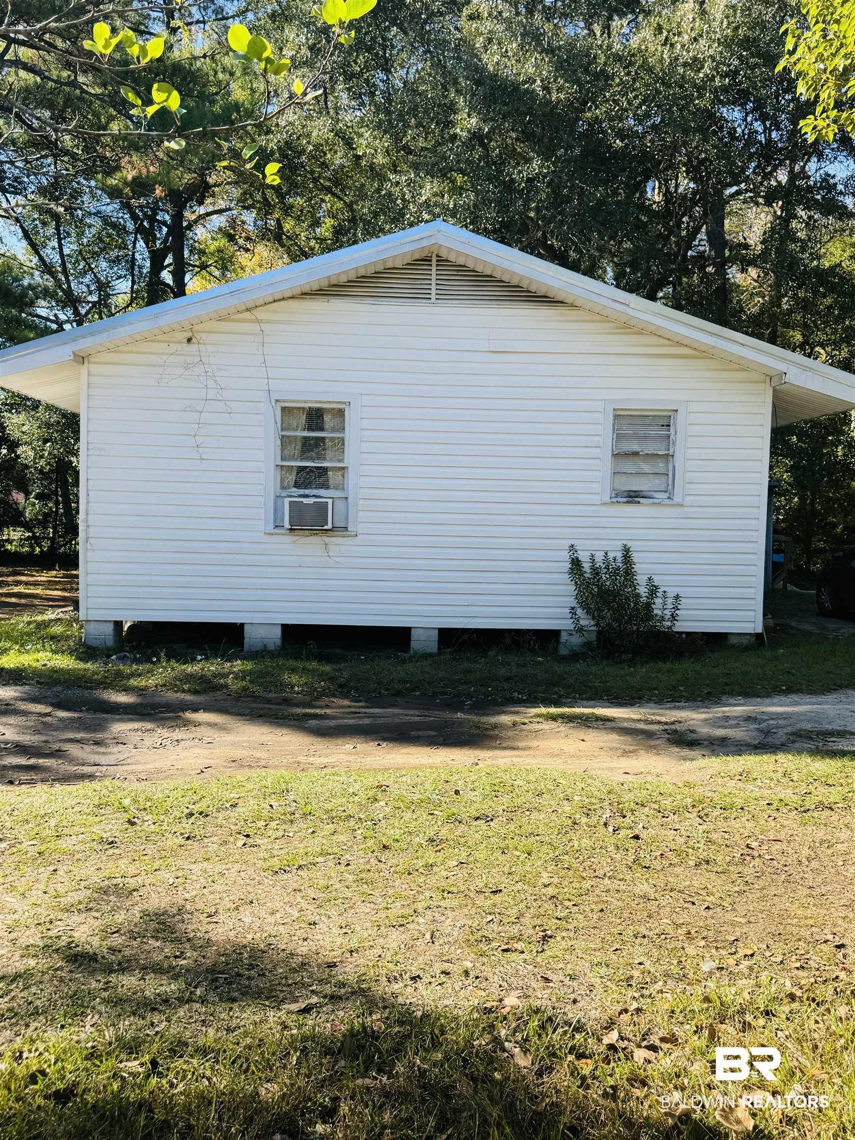 1616 Gill Road Mobile, AL 36605 - Photo 12 of 12 View of side of home with a yard and cooling unit