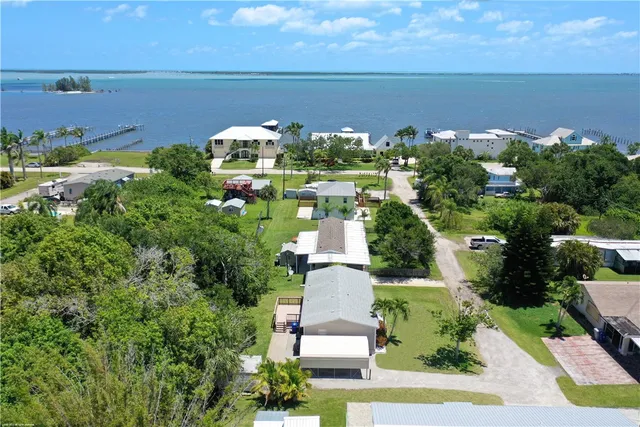 a kitchen with granite countertop white cabinets white stainless steel appliances and sink