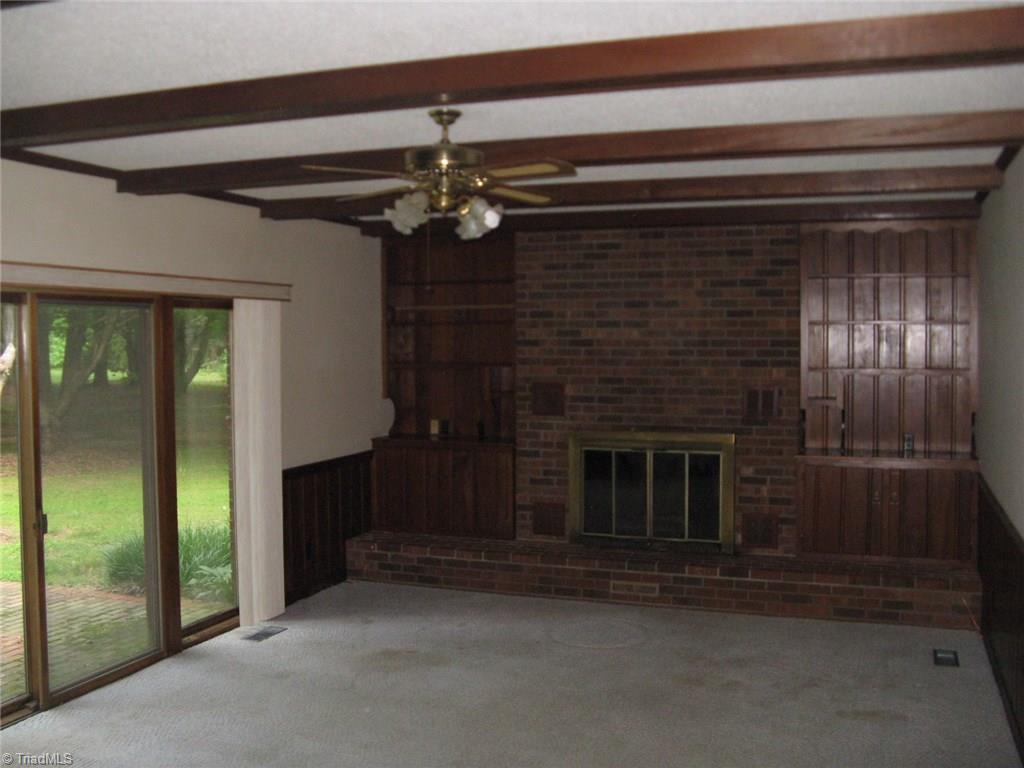 5204 Saddle Brook Road Oak Ridge, NC 27310 - Photo 8 of 29 Spacious Rustic Den with Built Ins and Wooden Beams.