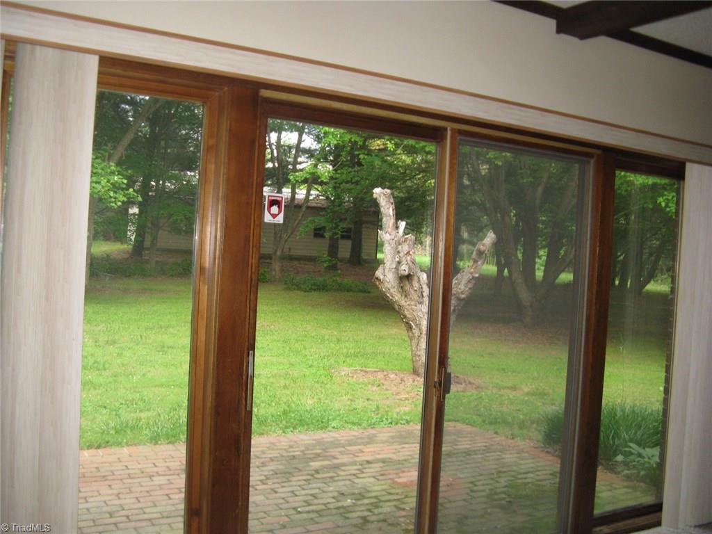 5204 Saddle Brook Road Oak Ridge, NC 27310 - Photo 9 of 29 Exit from Den to Patio and Back Yard