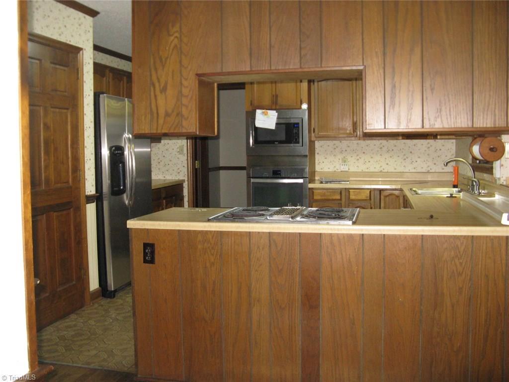 5204 Saddle Brook Road Oak Ridge, NC 27310 - Photo 10 of 29 Kitchen with Stainless Steel Appliances
