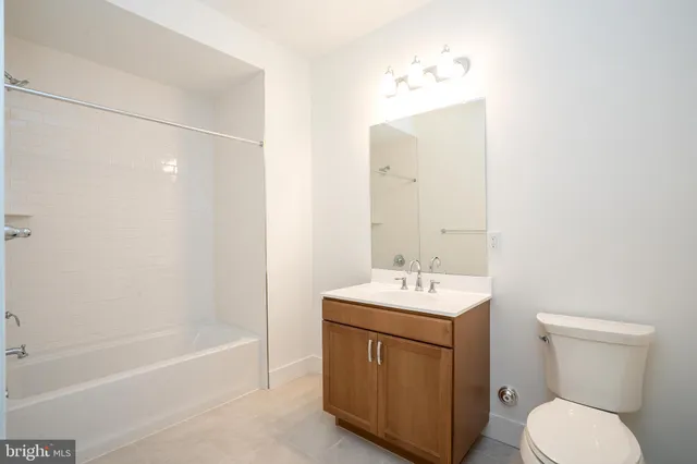 a bathroom with a sink toilet vanity and bathtub