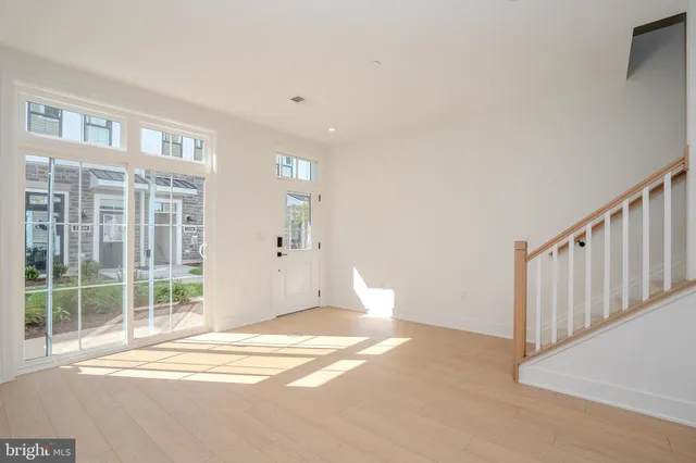 a view of a livingroom with wooden floor and a window