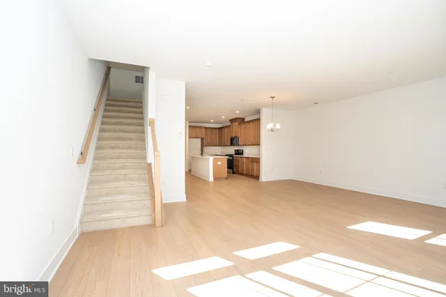 a view of kitchen and hall with wooden floor