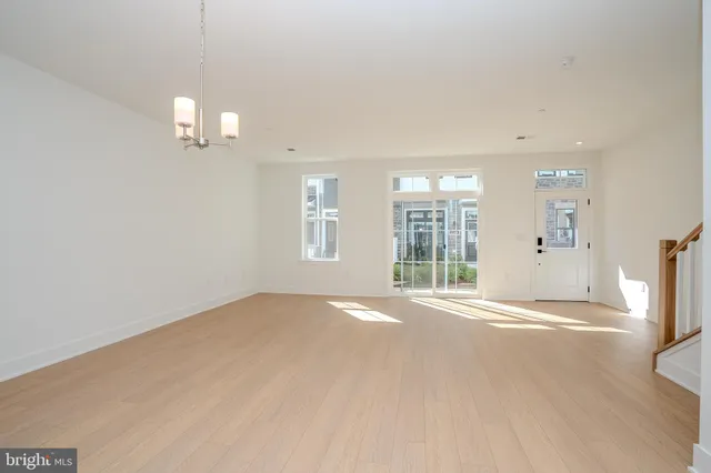 an empty room with windows and entrance