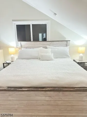 a large white bed in a white room