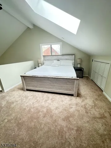 a spacious bedroom with a bed and window