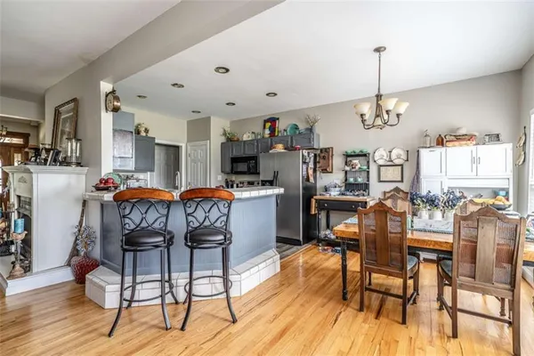 a dining room with furniture a chandelier and wooden floor