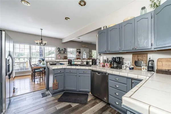 a kitchen with granite countertop cabinets stainless steel appliances and dining table