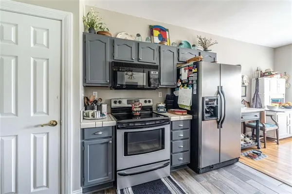a kitchen with stainless steel appliances granite countertop a stove a refrigerator and a refrigerator