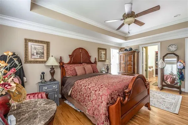 a bedroom with a bed and a chandelier
