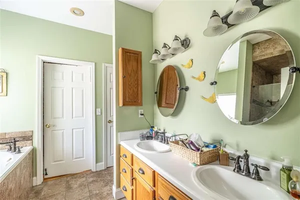 a bathroom with a mirror sink and vanity