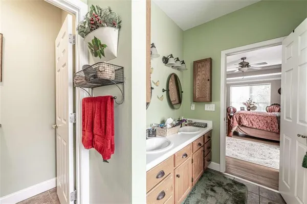 a en suite bathroom with a sink double vanity and mirror