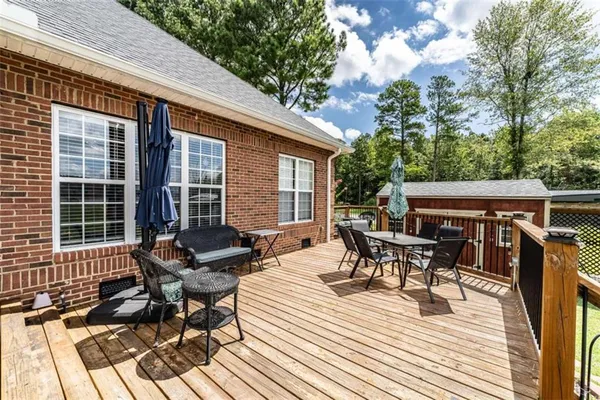 a view of a house with a yard and sitting area