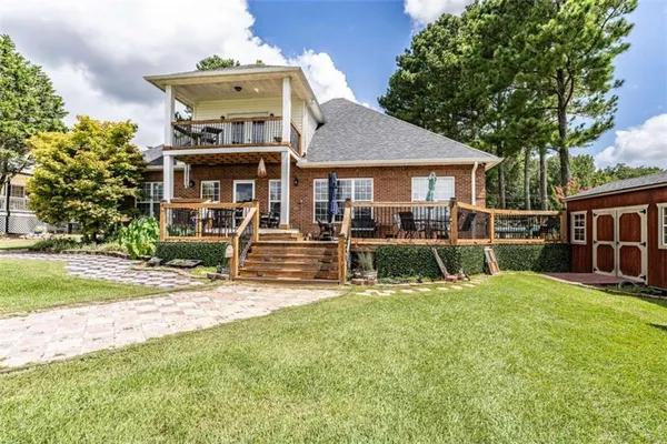 a view of a house with a yard and furniture