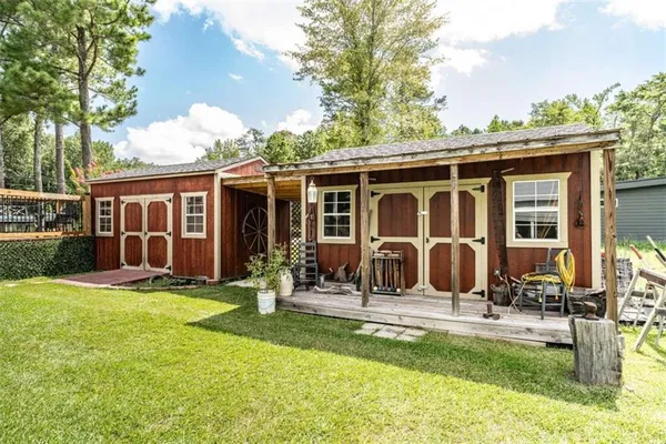 a view of swimming pool with lawn chairs and plants