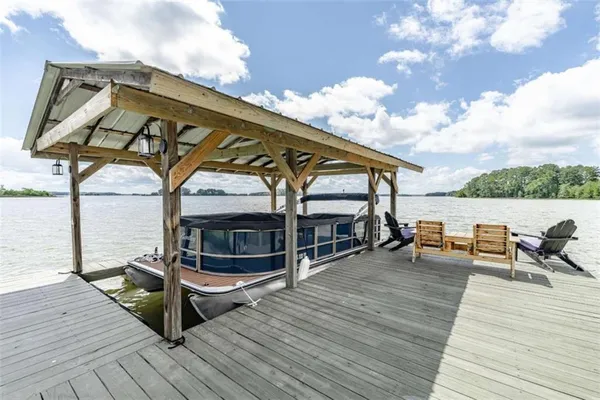 a view of a patio with a table chairs and wooden floor