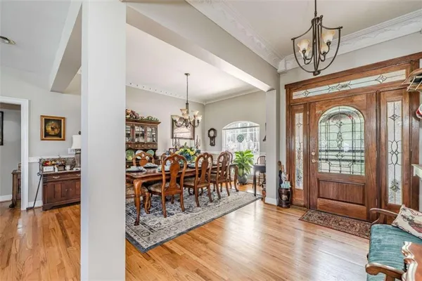 a view of a livingroom with furniture wooden floor and a chandelier