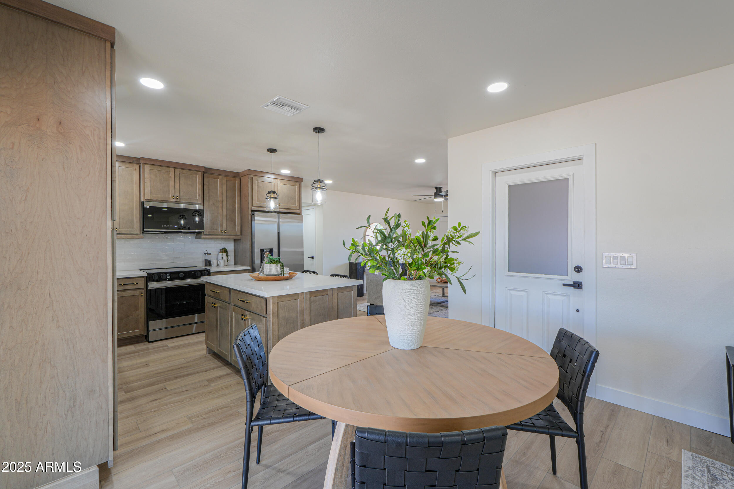 6502 East Rustic Drive Mesa, AZ 85215 - Photo 12 of 40 a kitchen with a table and chairs in it