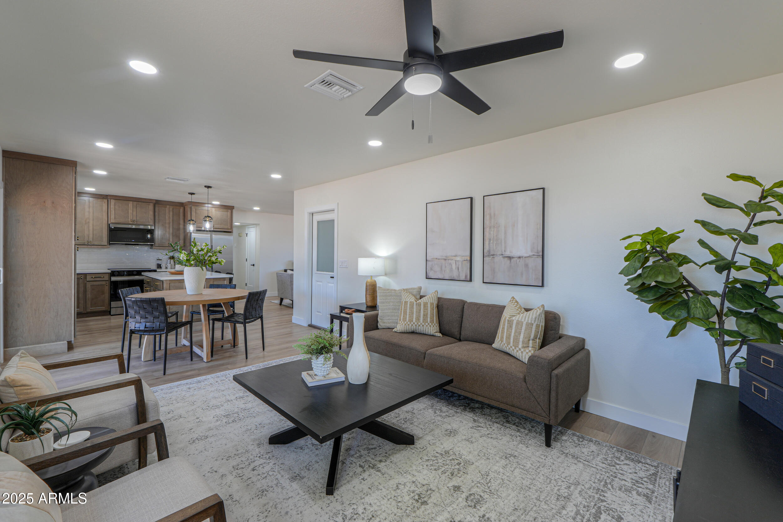 6502 East Rustic Drive Mesa, AZ 85215 - Photo 15 of 40 a living room with furniture kitchen view and a potted plant