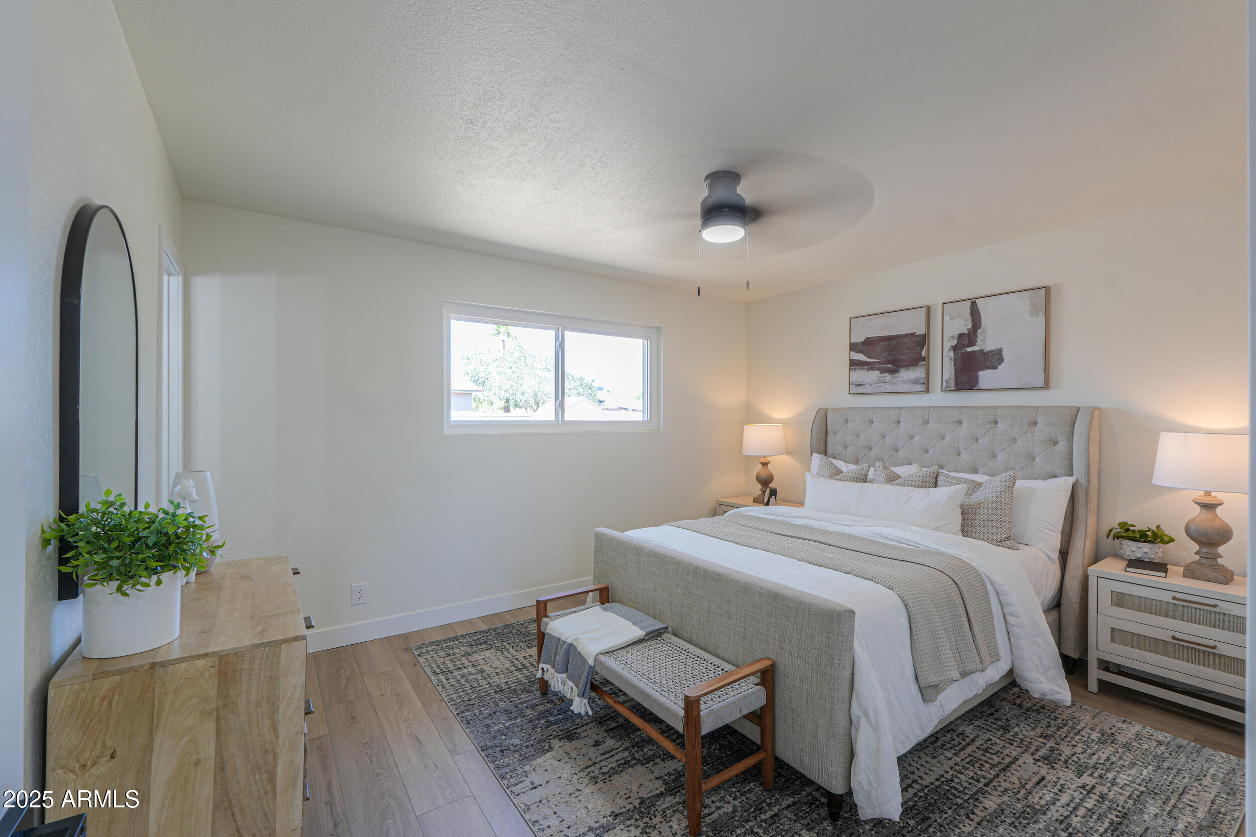 6502 East Rustic Drive Mesa, AZ 85215 - Photo 16 of 40 a bedroom with a bed and a potted plant